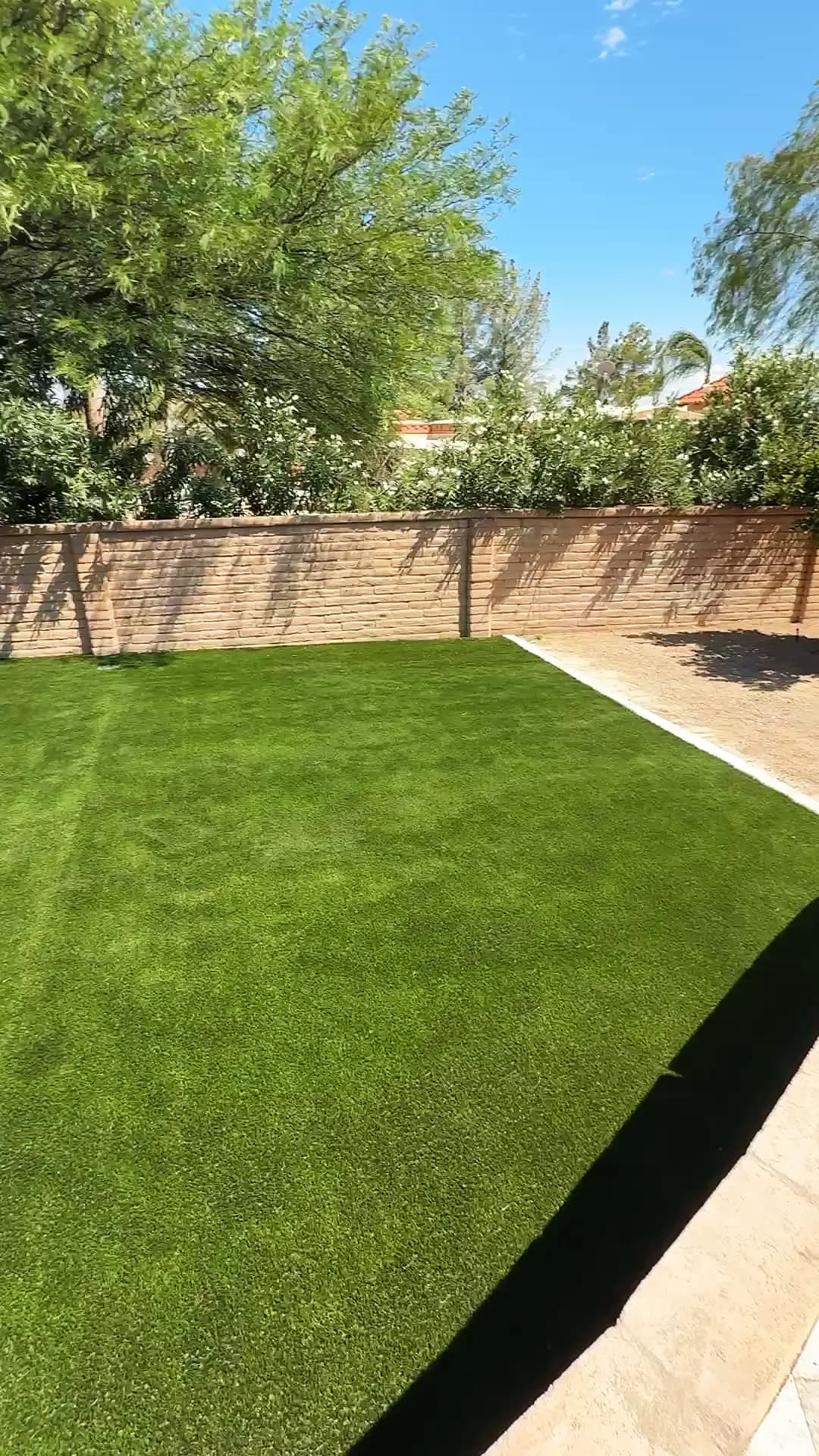 Pool and attached spa surrounded by silver travertine decking in Tucson